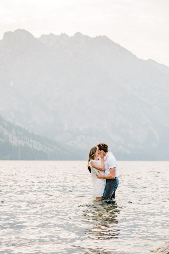 Grand teton engagment, couple kissing in water