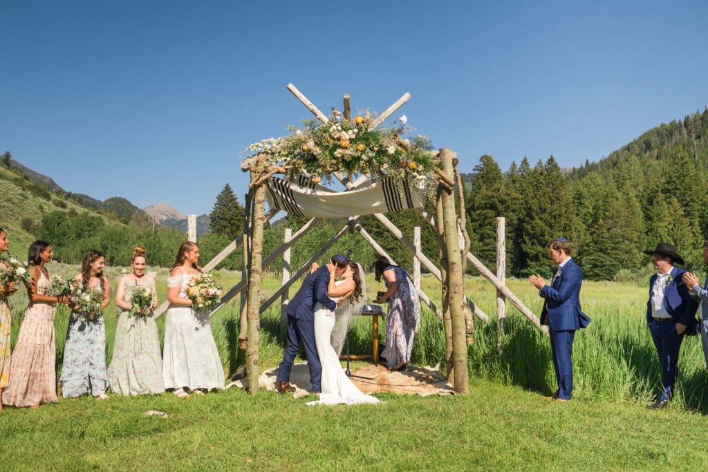 Bride and groom kissing at moose creek ranch wedding venue 