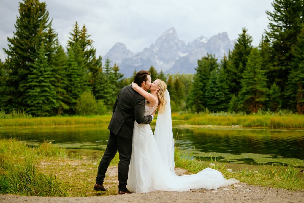 Bride and Groom kiss at their swabacher's landing elopement in grand teton national park