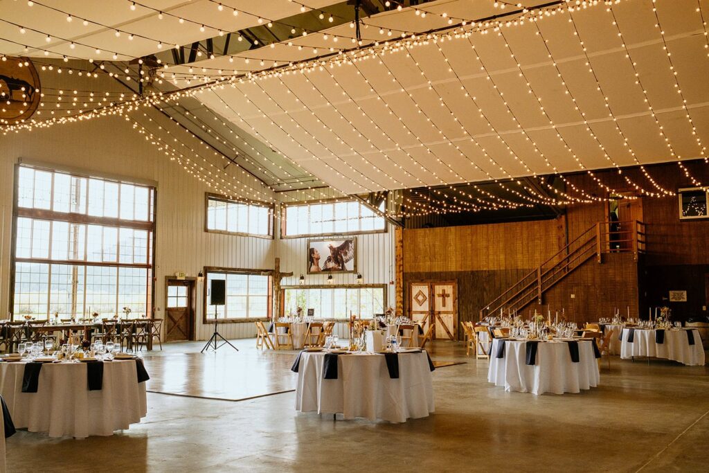 Diamond Cross Ranch Wedding reception table set up in barn