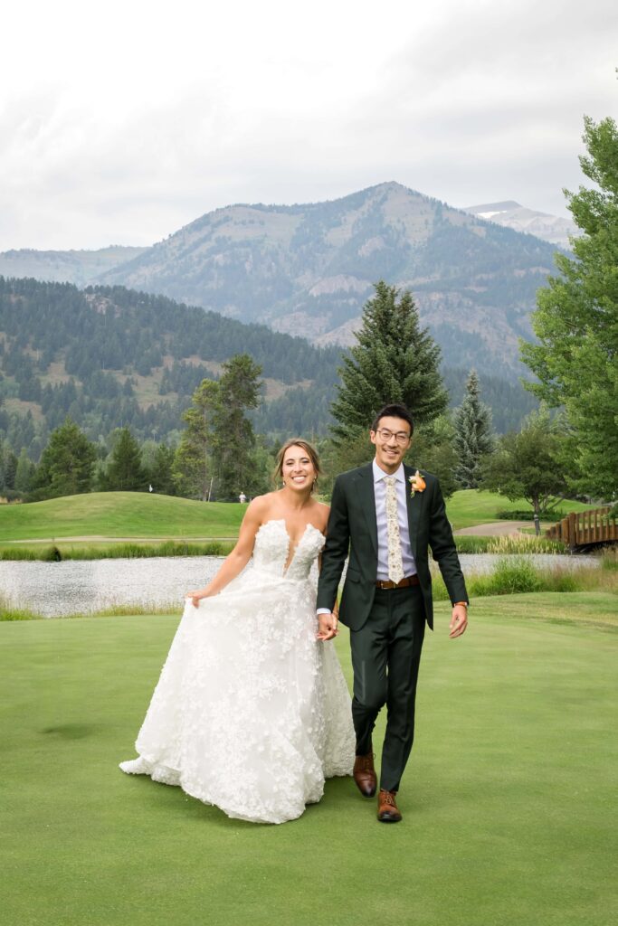 bride and groom walking on golf turf 