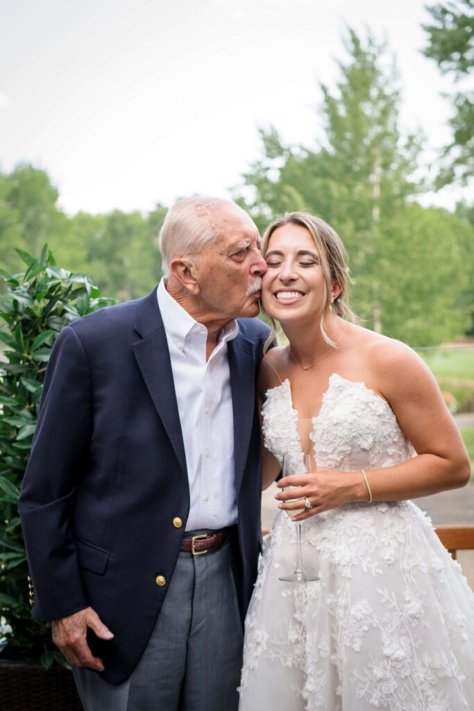 grandpa kissing bride on cheek 