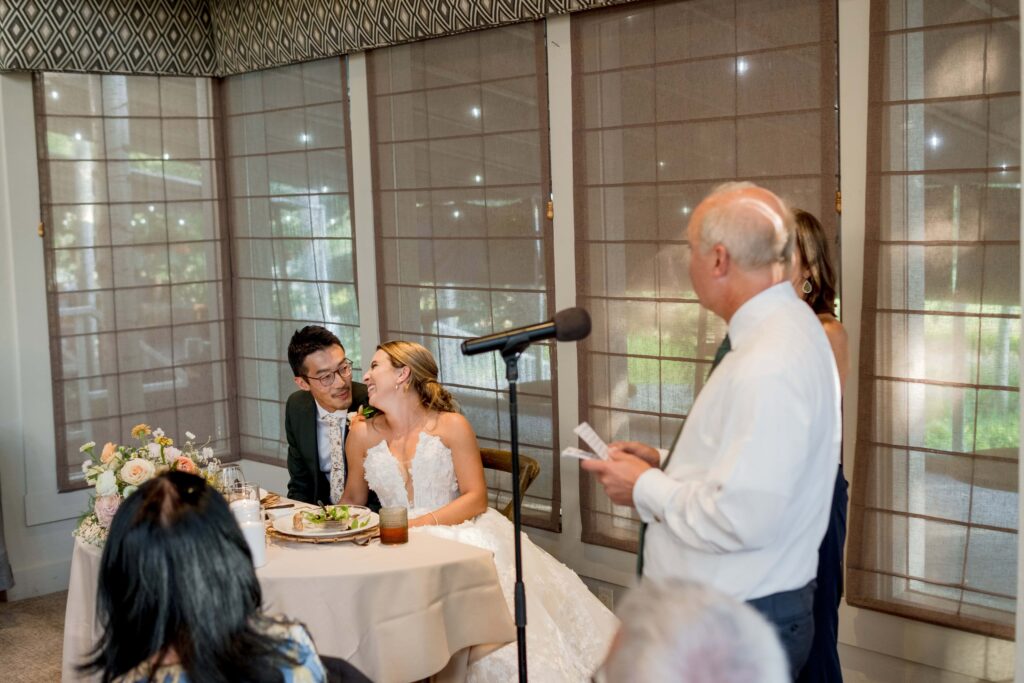 bride laughs at wedding speech