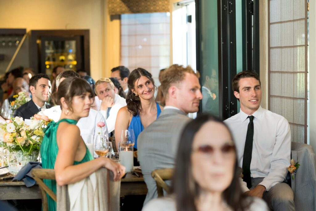 guest smiling at wedding speeches