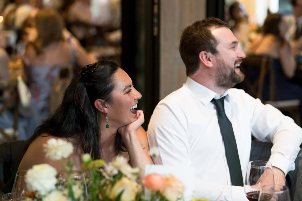 Guests laughing at wedding speech