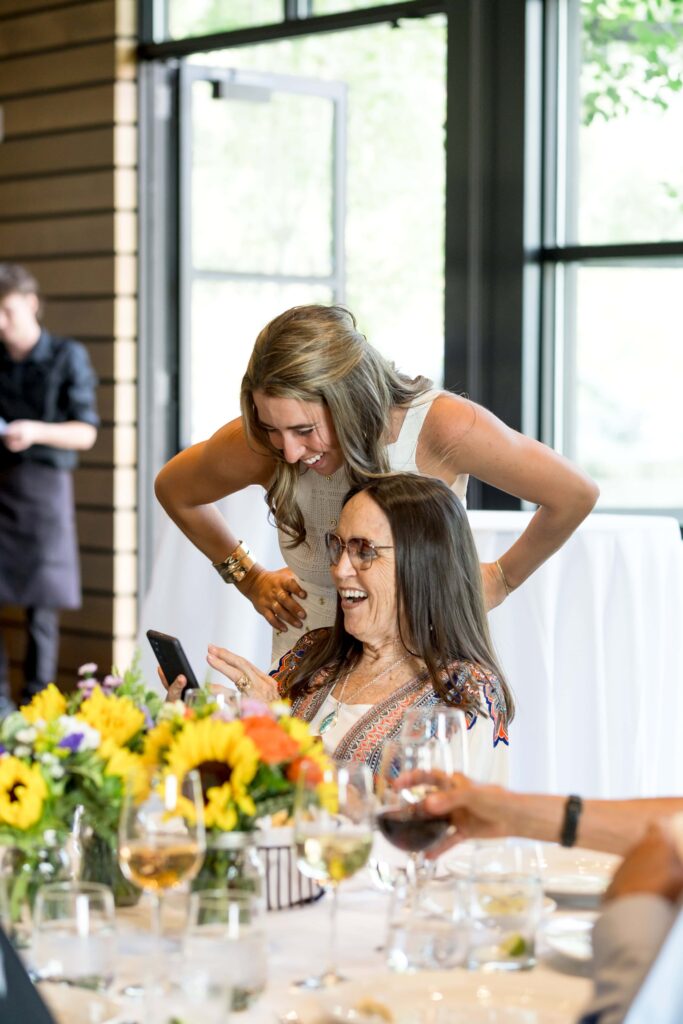 bride laughing with her grandma at wedding dinner in jackson hole