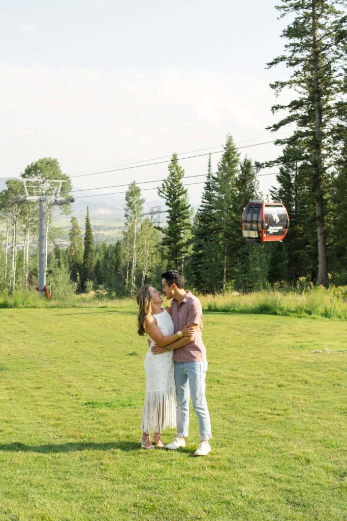 bride and groom kiss with jackson hole resort gondola in background