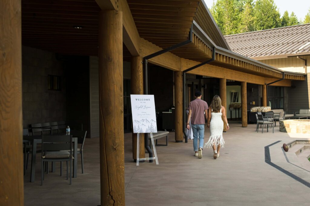 bride and groom walk to welcome dinner at jackson hole resort