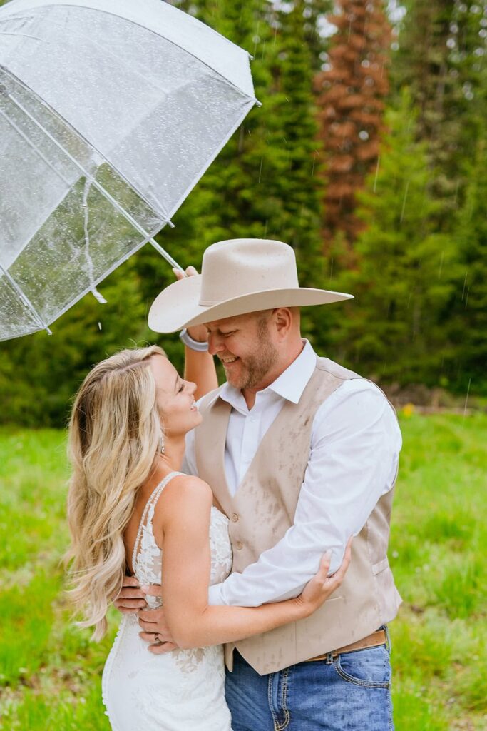 wedding portraits with umbrella in the rain.