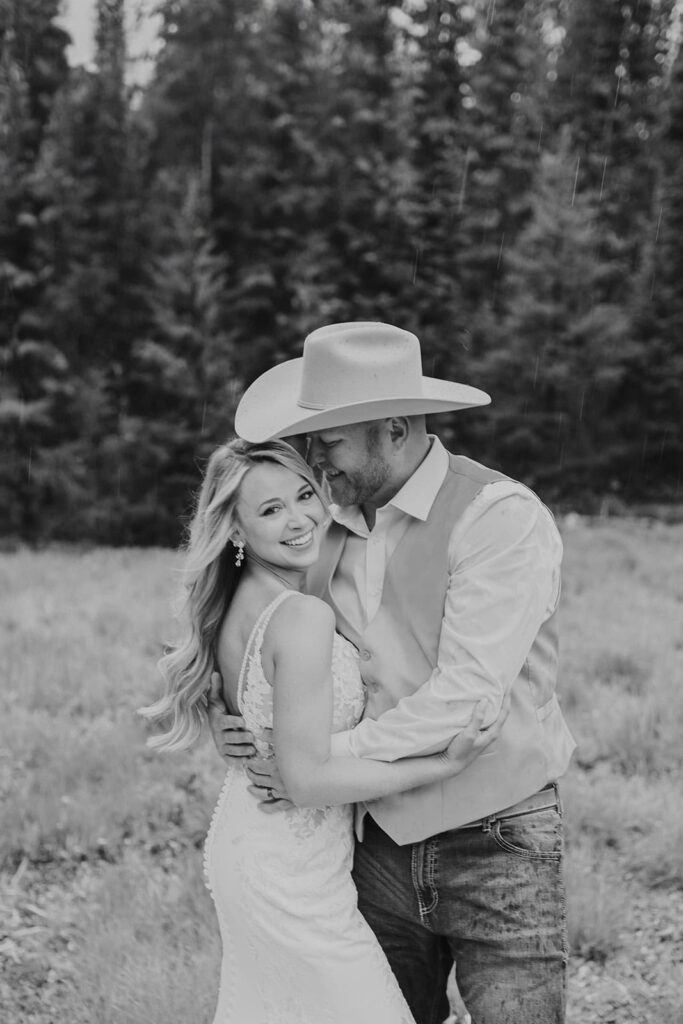 black and white wedding portraits with umbrella in the rain.