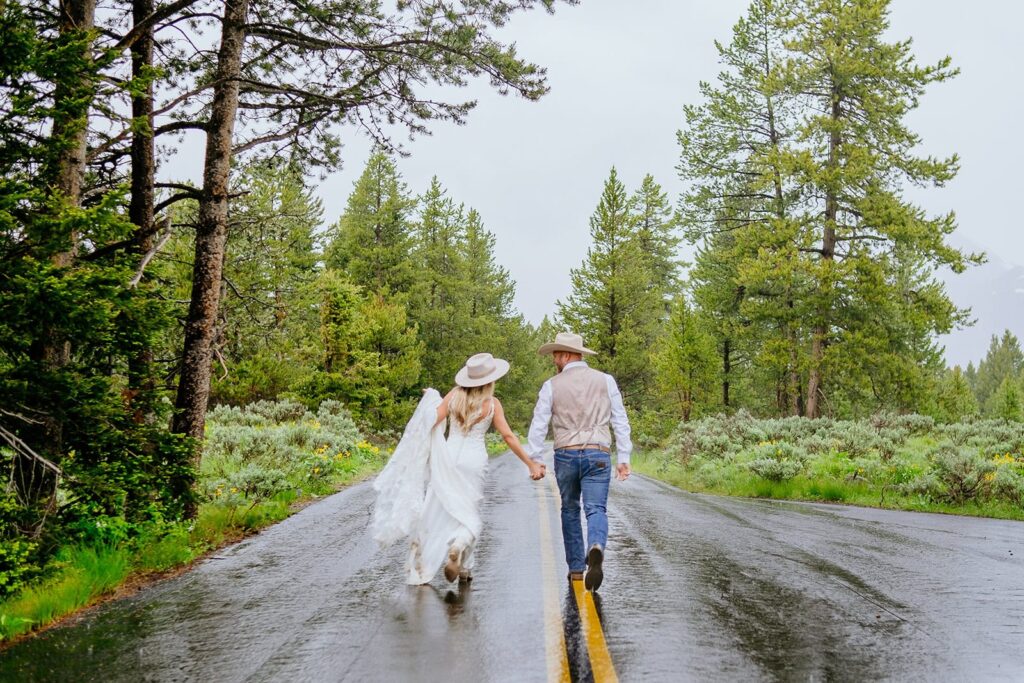 bride and groom running on road grand teton wedding portraits