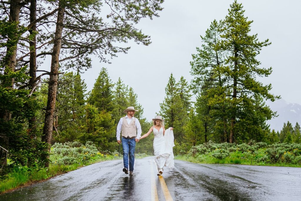 bride and groom running on road grand teton wedding portraits