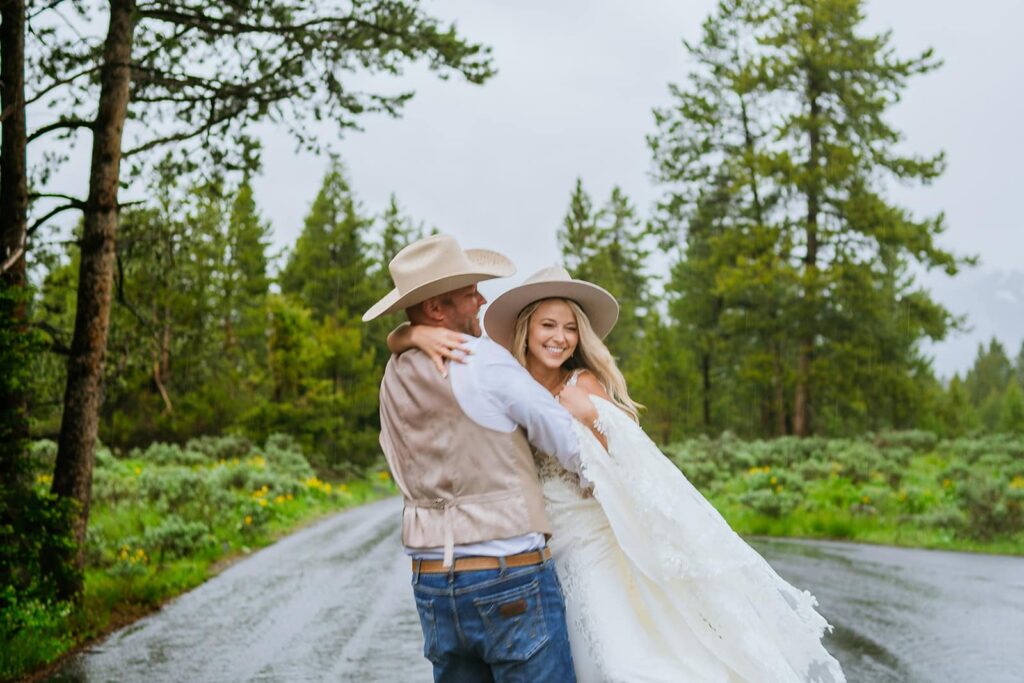 bride and groom running on road grand teton wedding portraits