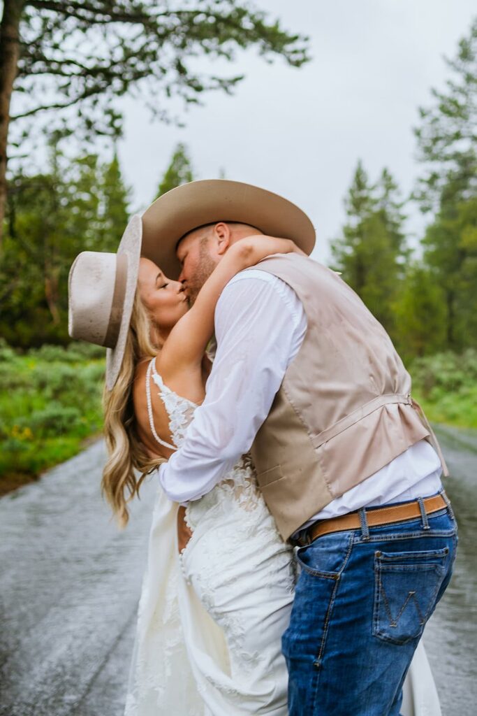 bride and groom kissing on road grand teton wedding portraits