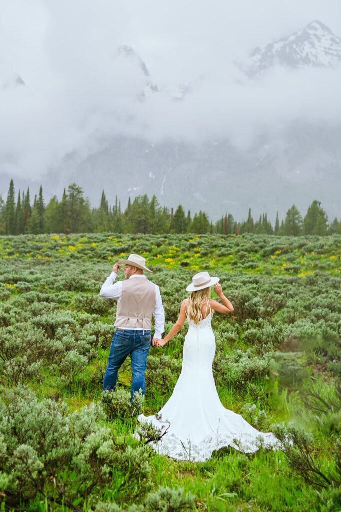 bride and groom with cowboy hats grand teton wedding portraits