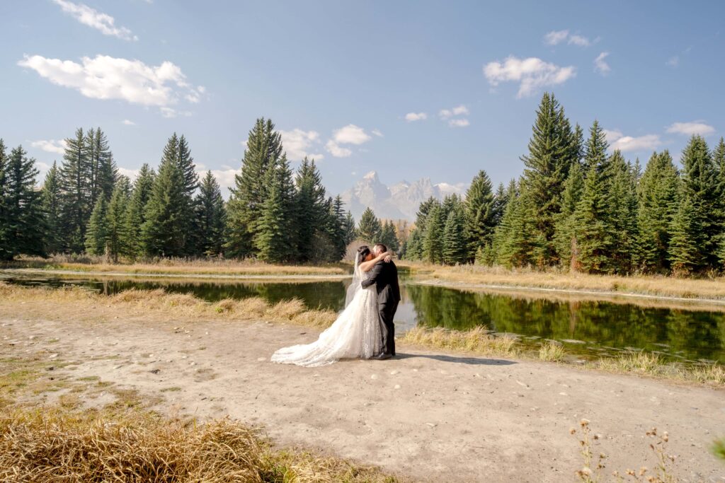 bride and groom kissing at swabacher's landing, Grand Teton National Park