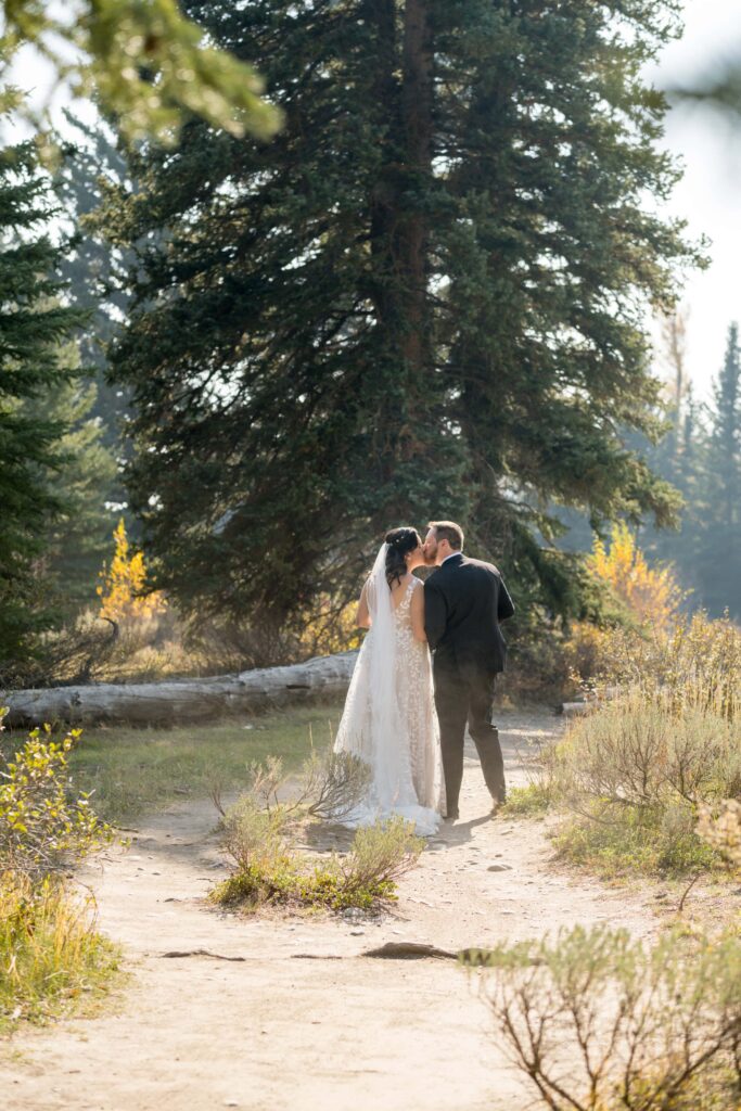 bride and groom walking down trail