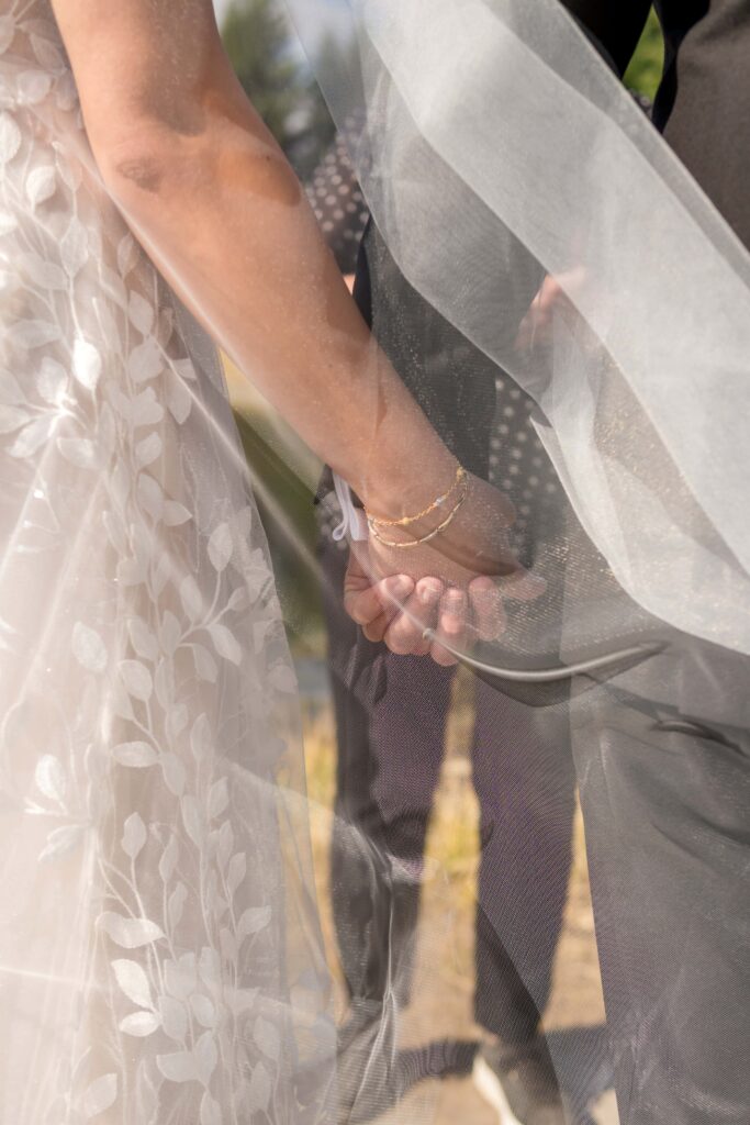 bride and groom holding hands