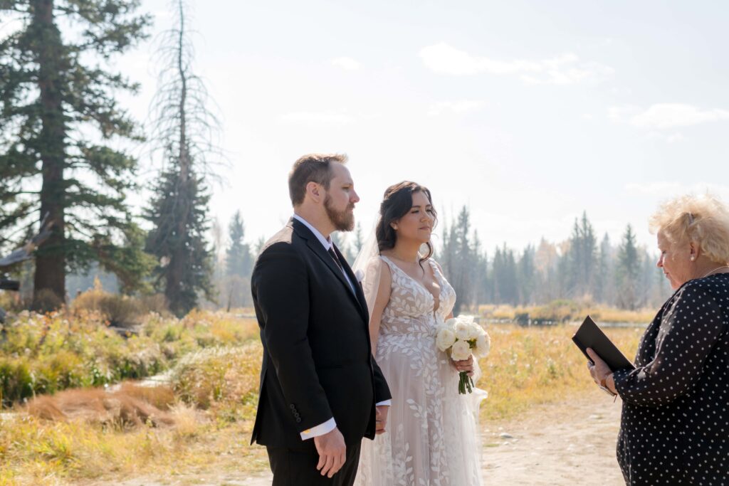 bride and groom looking at officiant getting married 