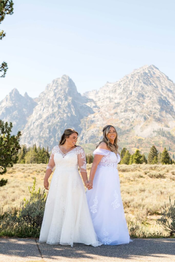 two brides holding hands in grand teton national park