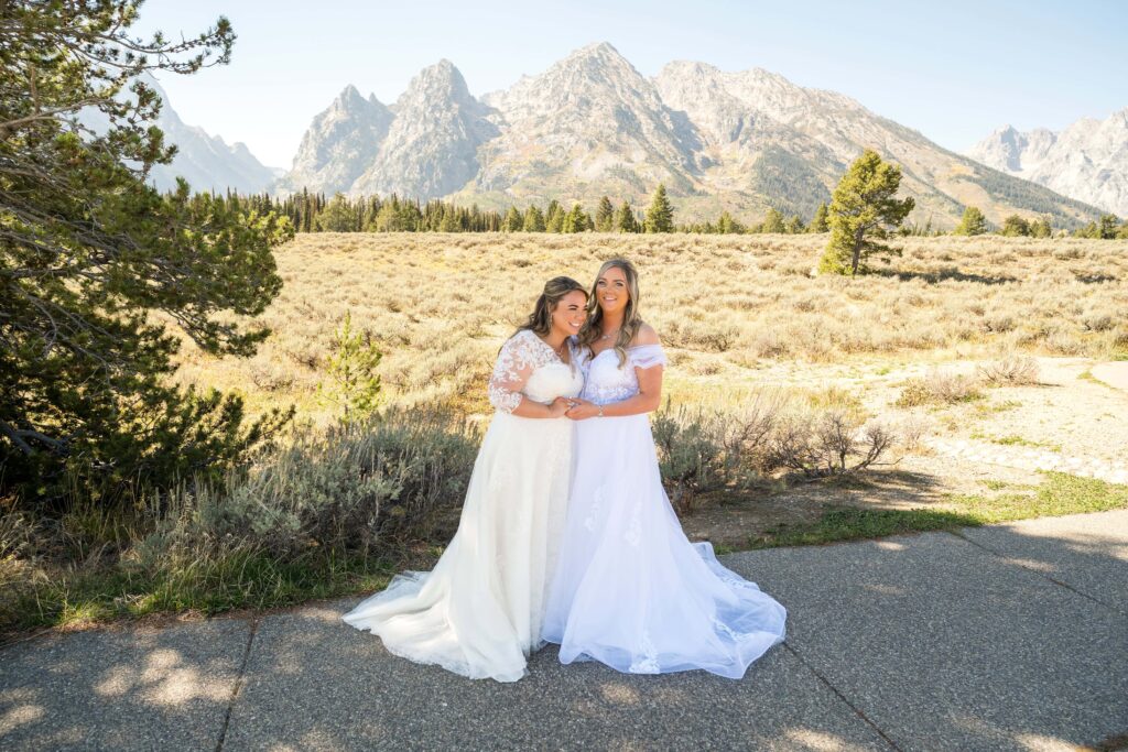 two brides holding hands in grand teton national park