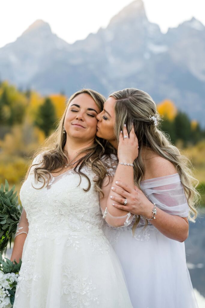 two brides kissing on the cheek