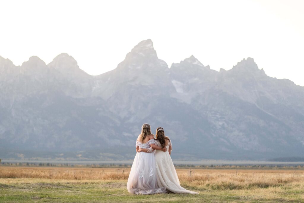 two brides with tetons in back