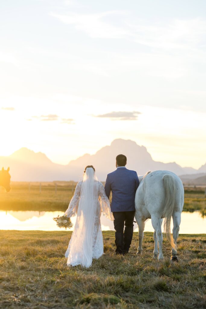 couple taking photos on their wedding day in jackson hole wyoming at diamond cross ranch