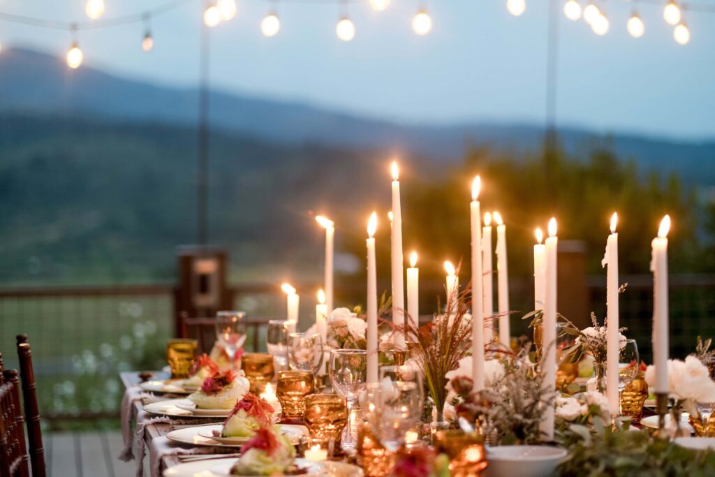 A scenic dinner display at a Jackson Hole elopement dinner. Candles are lit across the table with a picturesque tablescape 