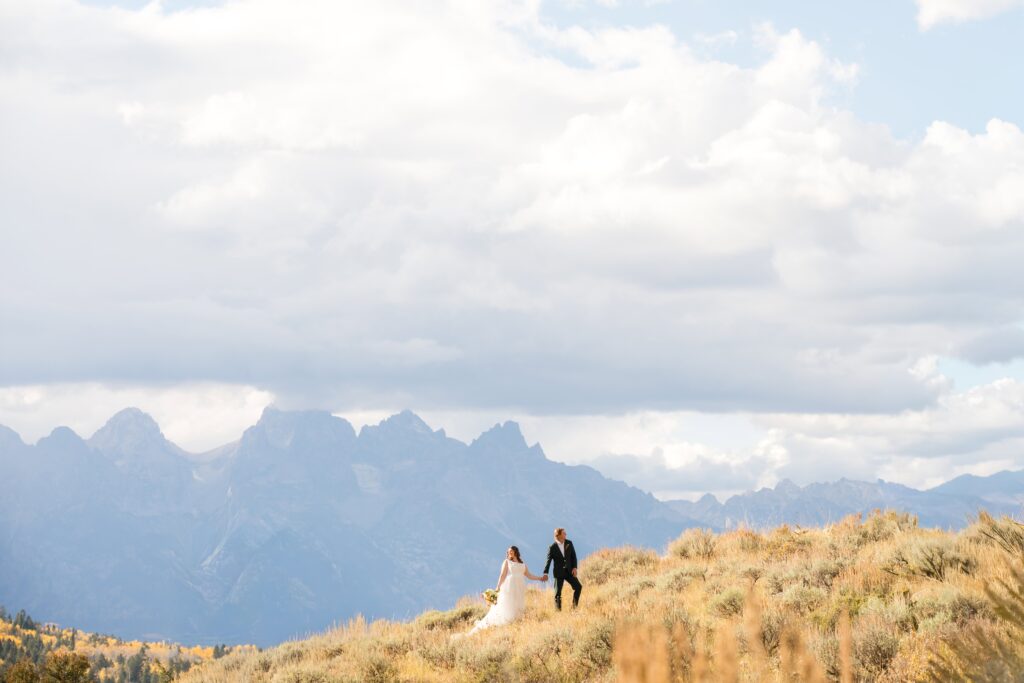 A picturesque wedding at the Wedding Tree in Grand Teton National Park, with vibrant fall foliage in Jackson Hole, Wyoming.
