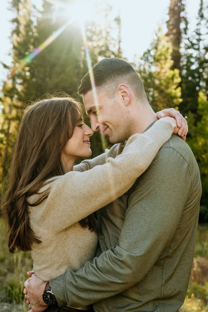 Couple kissing with light flare in background