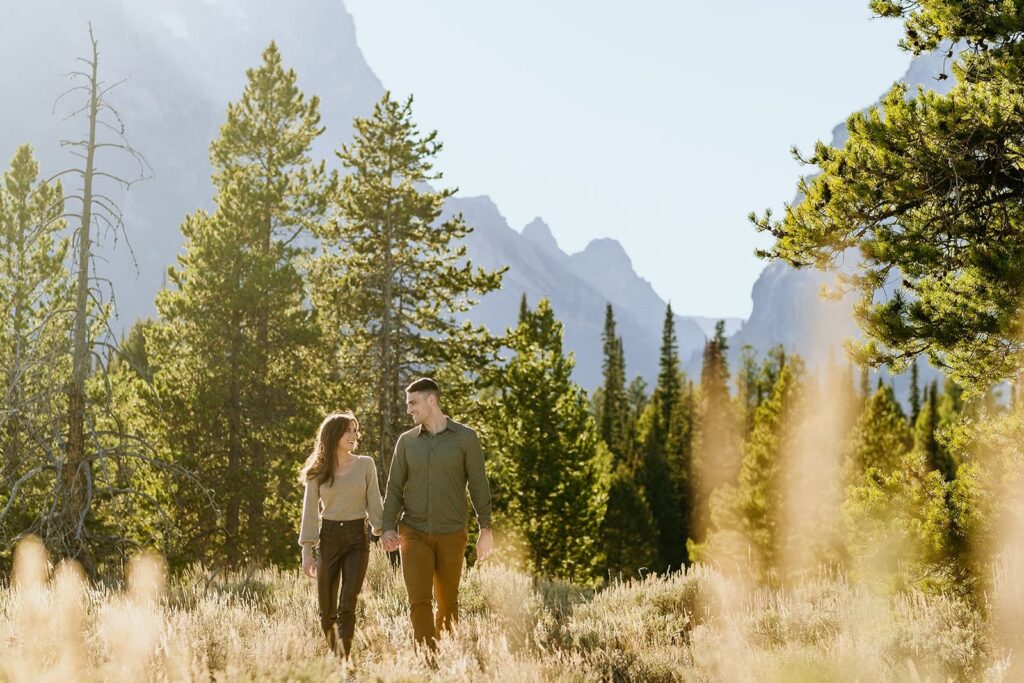 Couple walking through forrest in grand teton national park