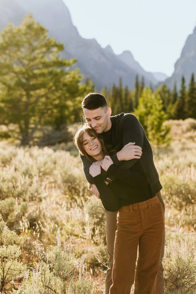 Couple hugging with large mountains in the background