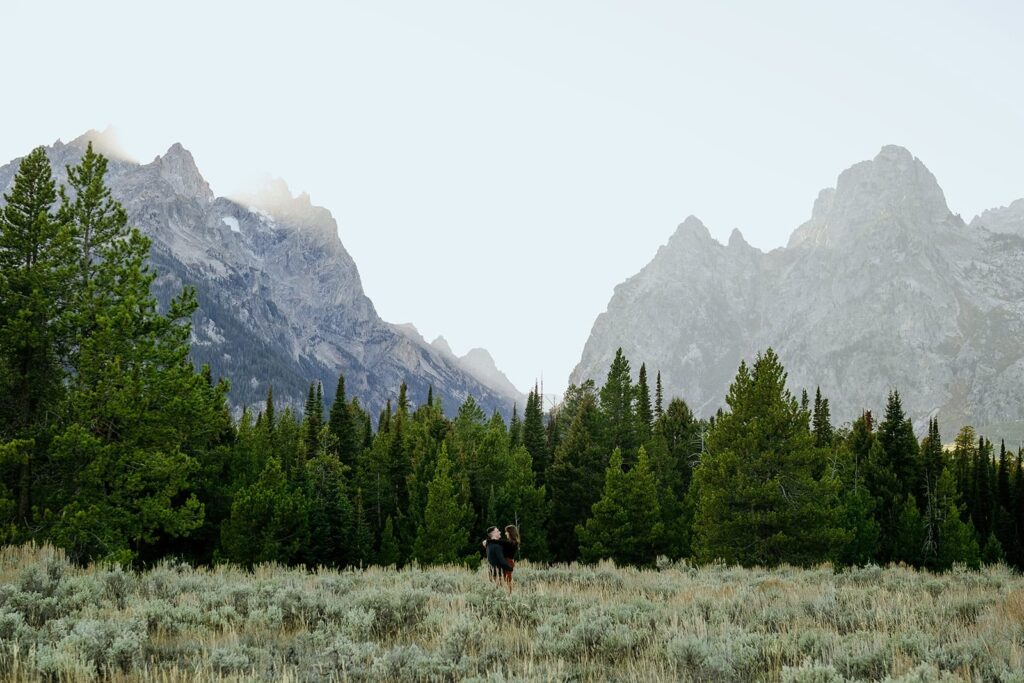 Grand Tetons with couple hugging