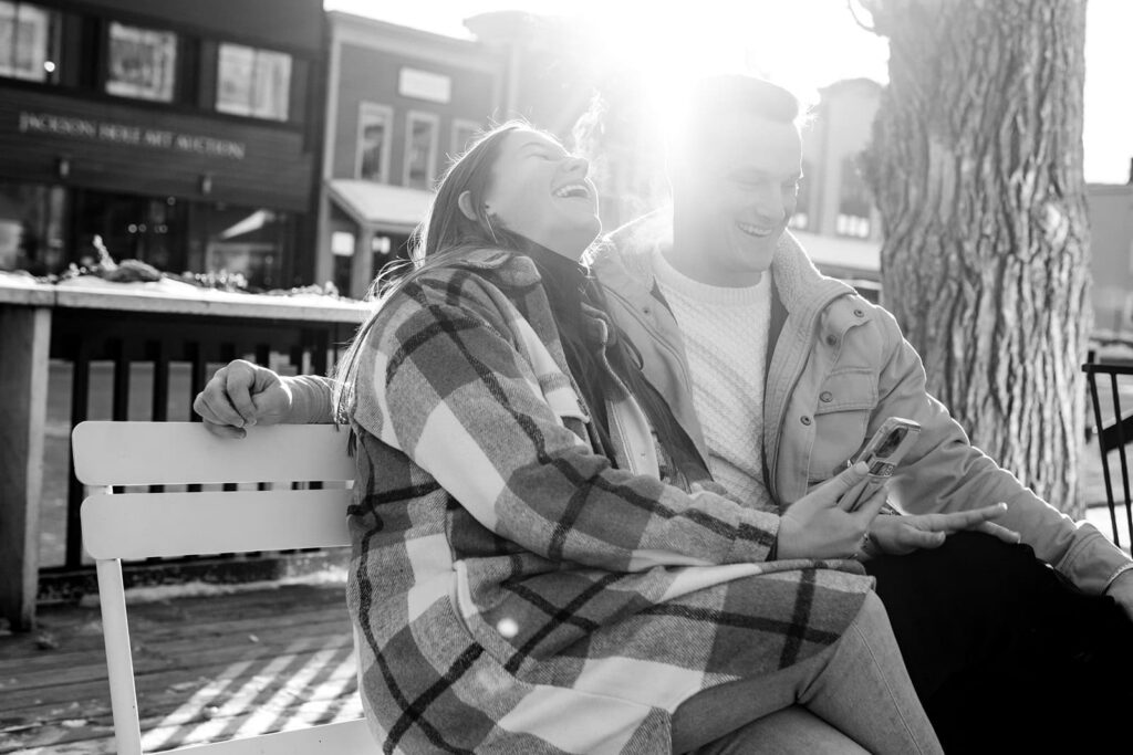 A couple shares a laugh on the pattio of persephonies bakery. in jackson hole